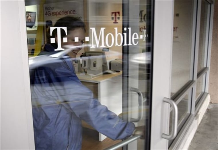A customer walks out of a T-Mobile store in Palo Alto, Calif., Friday, Feb. 25, 2011. Subscribers on contract-based cell phone plans hung up on T-Mobile USA in record numbers in the fourth quarter, as it continues to lose the battle against larger carriers. 